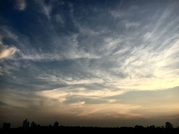 Low angle view of silhouette trees against sky