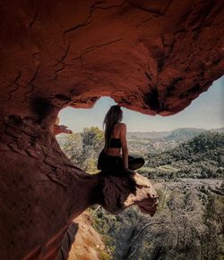 Woman sitting on rock