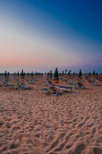 Scenic view of beach against sky during sunset