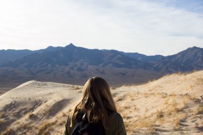 Woman on landscape against mountains