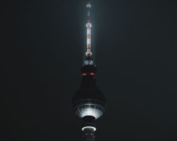 Illuminated tower against sky at night