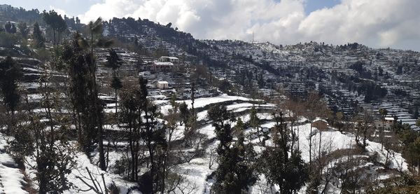 Scenic view of snow covered mountains against sky