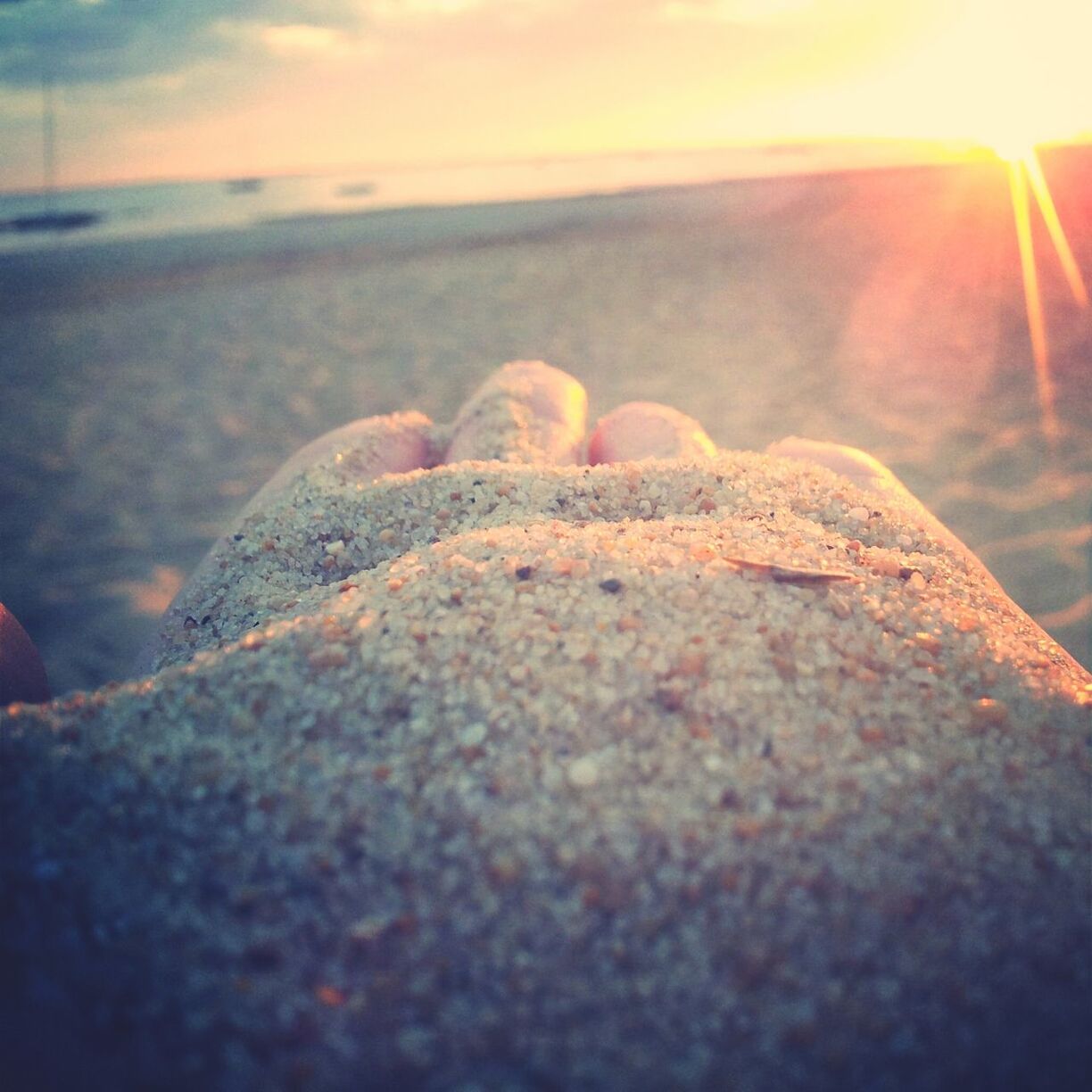 sun, beach, tranquility, sunset, sunlight, sky, tranquil scene, nature, scenics, sea, beauty in nature, sand, rock - object, water, sunbeam, surface level, lens flare, close-up, shore, selective focus