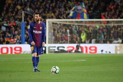 People playing soccer ball on field