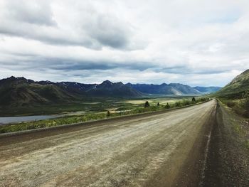 Empty road along countryside landscape