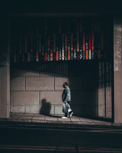 Rear view of people walking on building