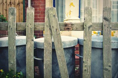 Close-up of closed wooden fence against building