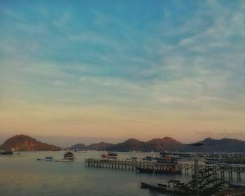 Boats in sea at sunset