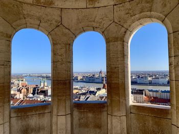 Panoramic view of sea and buildings against blue sky