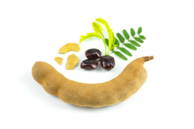 High angle view of fruits in plate against white background