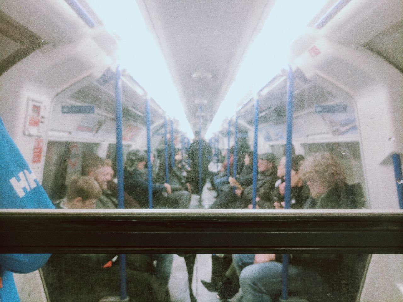 PEOPLE SITTING ON TRAIN AT CITY