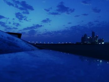 Illuminated city against sky at night