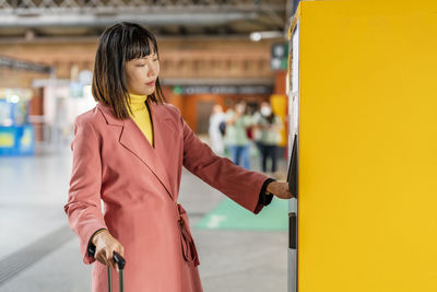 Woman withdrawing money from atm machine