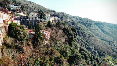 Houses on mountain against sky