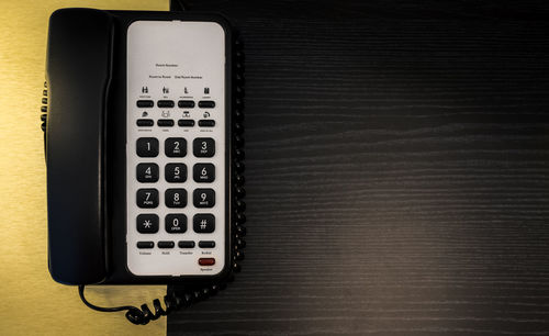 High angle view of telephone on table