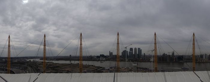 View of harbor against cloudy sky