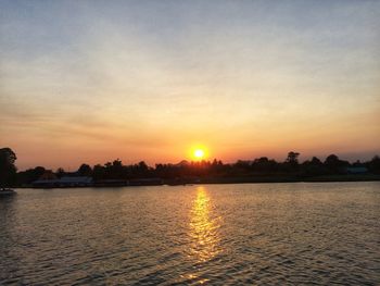 Scenic view of lake against sky during sunset