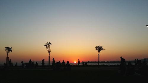 Silhouette of people on beach during sunset