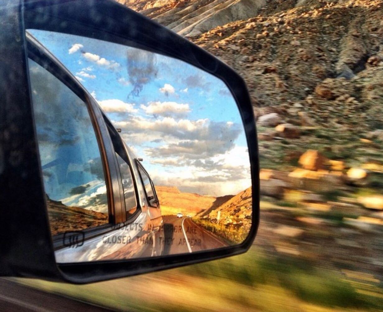 REFLECTION OF CAR ON SIDE-VIEW MIRROR