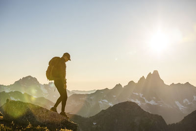 Tranquil scene of backpacker hiking across mountain summit.