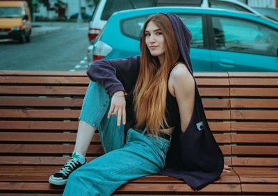 Full length of woman sitting on seat