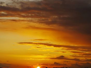 Low angle view of dramatic sky during sunset