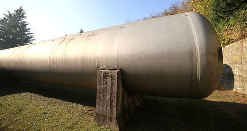 Close-up of rusty pipe on field against sky