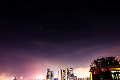 Low angle view of illuminated cityscape against sky