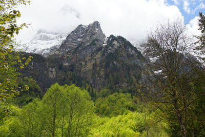 Scenic view of mountains against cloudy sky