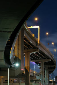 Illuminated bridge against sky at night