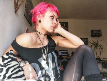 Portrait of young woman sitting at home