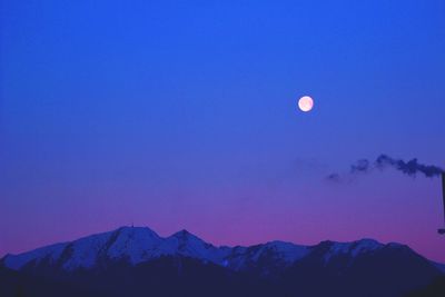 Scenic view of mountains against blue sky