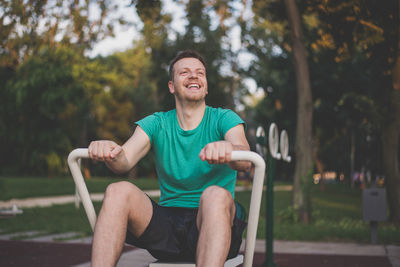 Man sitting on seat in park