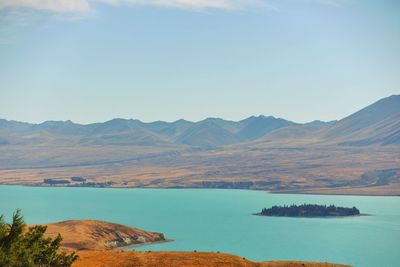 Scenic view of lake and mountains against sky