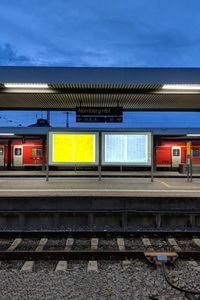 Train at railroad station against sky at dusk