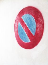 Close-up of red object over white background