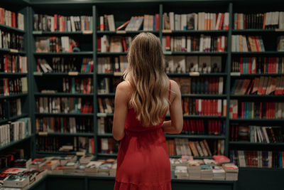 Rear view of woman reading book