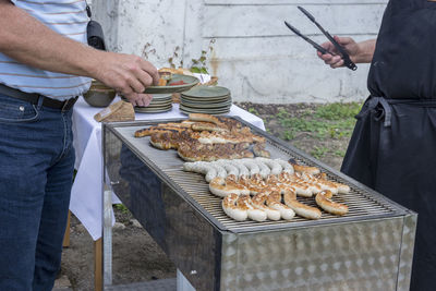 Man standing on barbecue grill