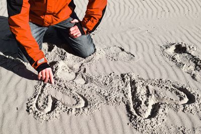 Low section of man on sand