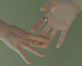 Close-up of woman hand over green background
