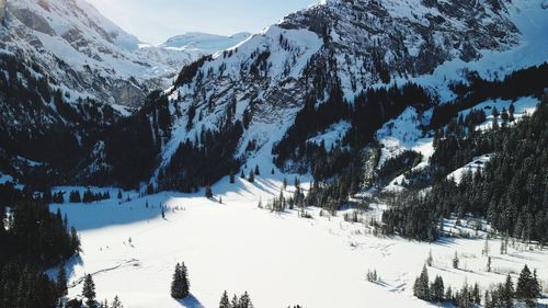 Scenic view of snow covered mountains against sky