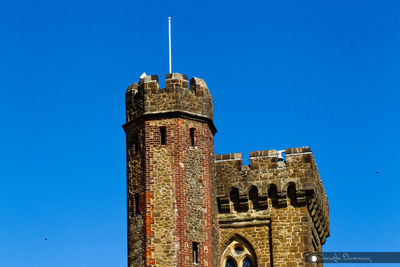 Low angle view of historical building against blue sky