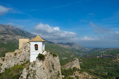 Historic building by mountain against sky