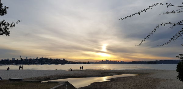 Scenic view of beach against sky during sunset