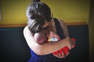 Woman holding toy at home