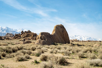 Rock formations on landscape against sky