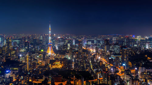 High angle view of illuminated city buildings at night