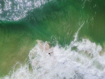 High angle view of people swimming in sea