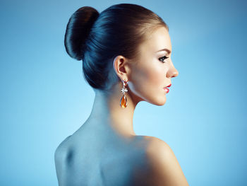 Portrait of woman against blue background