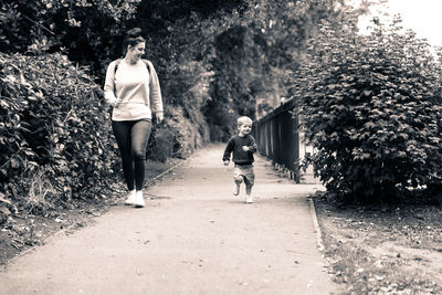 Man and woman walking on plants